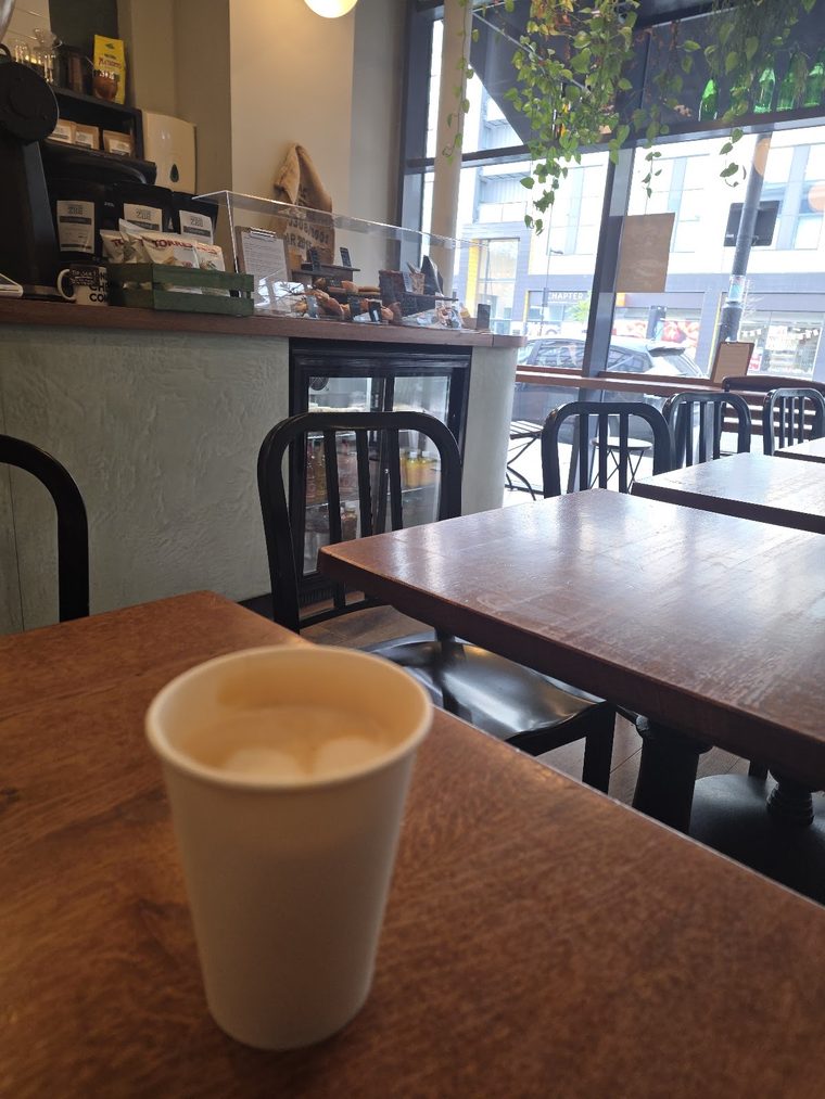 Takeaway coffee cup on a table by the window