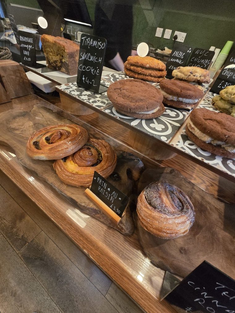Cruffins and cinnamon swirls stacked on the pastry shelf